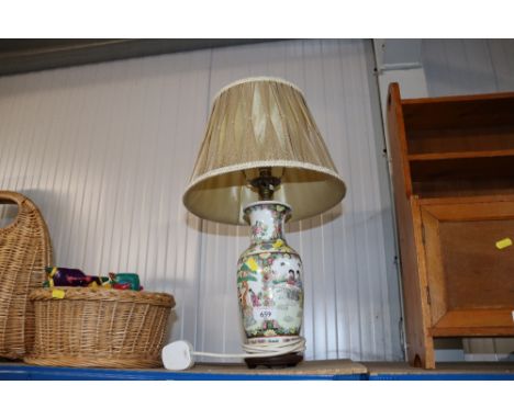 An Oriental vase converted to a table lamp 