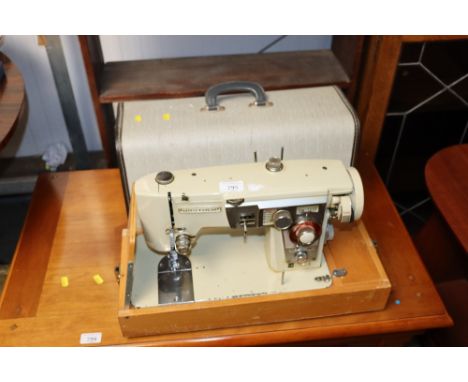 A Brother electric sewing machine in fitted case, sold as collectors item
