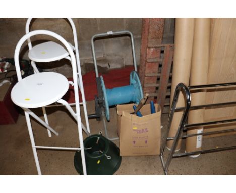 A hose reel together with a box of various hand tools ad a Christmas tree holder
