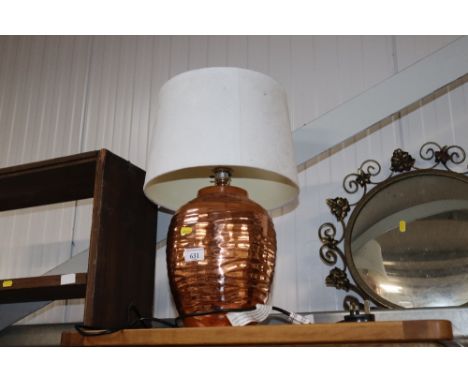 A copper table lamp and shade