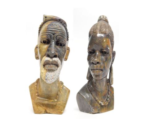 Two African carved heads of a man and a lady from the Mashona tribe, one signed R Mugari to base (2)