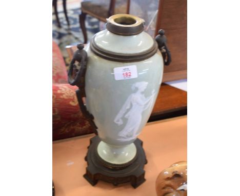 Oil lamp with pate sur pate decoration of a classical lady on celadon green ground   
