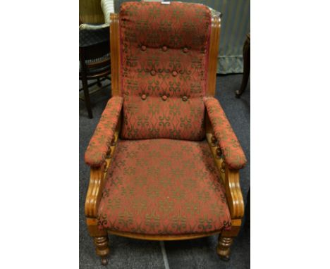 A Victorian mahogany salon arm chair button upholstered back, spindled arms, stuffed over seat, turned forelegs, ceramic cast