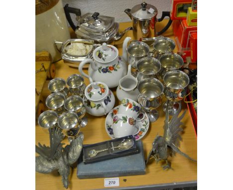 An E.P.N.S. three piece tea service;  a tea strainer;  a set of Regent pewter goblets;  a pair of fighting cockerels;  a Fren