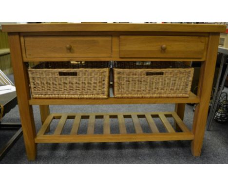 A contemporary light oak hall table, two short drawers above two shelves and two wicker baskets