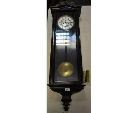 A 19th century ebonized Vienna wall clock, porcelain dial, subsidiary secondary dial, Roman numerals, twin winding holes, car