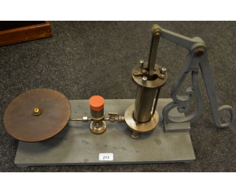 An early 20th century vacuum pump, cast metal base, manual pumping handle.