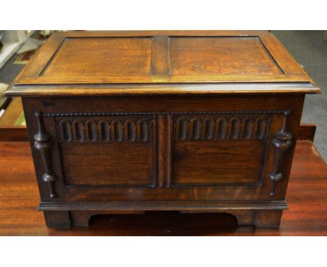 An early/mid 20th century oak fuel bin, metal liner, egg and dart moulded panels, bracket feet.