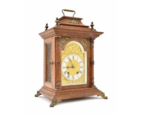 Lenzkirch oak two train mantel clock striking on a gong, the 4.5" brass arched dial with silvered chapter ring enclosing a ma