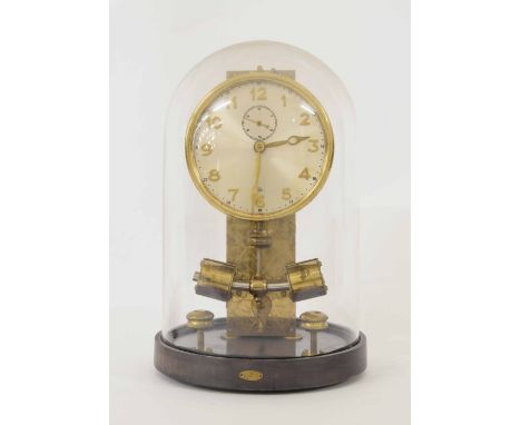 Ato electric mantel clock, the 4" silvered dial with subsidiary seconds dial, supported upon a circular mahogany base and und