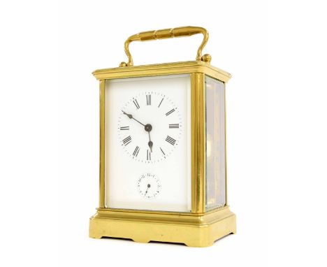 Striking carriage clock with alarm, the movement striking on a bell beneath the base, within a corniche brass case, 7" high (