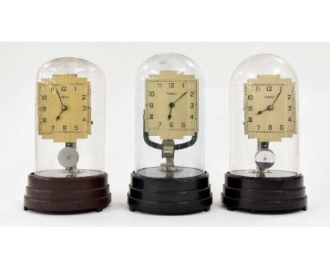 Three similar Tempex electric mantel clocks, all under domes and upon stepped circular Bakelite bases, approx 11" high (3)