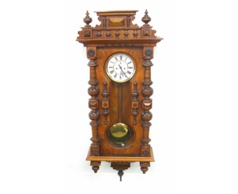 Walnut double weight Vienna regulator wall clock, the 7" white dial with subsidiary seconds dial, within a pillared glazed ca