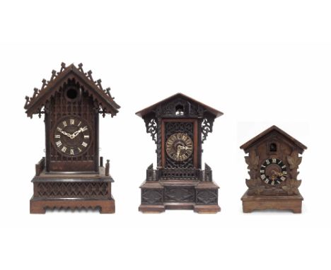 Black Forest two train cuckoo mantel clock, within a breakfront chalet case, 17" high; also another Black Forest clock with l