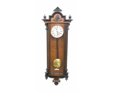 Walnut and ebonised single weight Vienna regulator wall clock, the 6.25" white dial with subsidiary seconds dial, within a gl