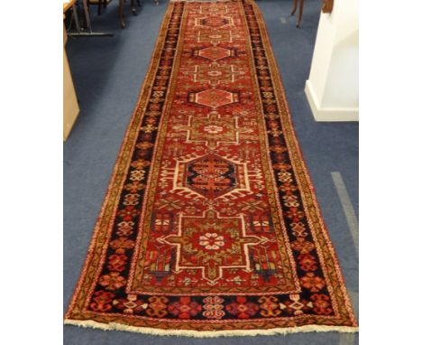 A Hamadan runner on red ground, approximately 455cm x 115cm