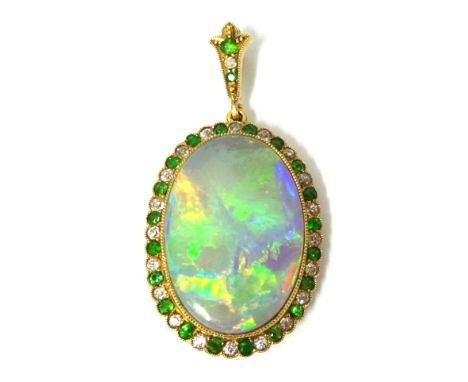 Antique opal pendant with a border of emeralds and diamonds set in yellow metal, approximately 28mm x 20mm