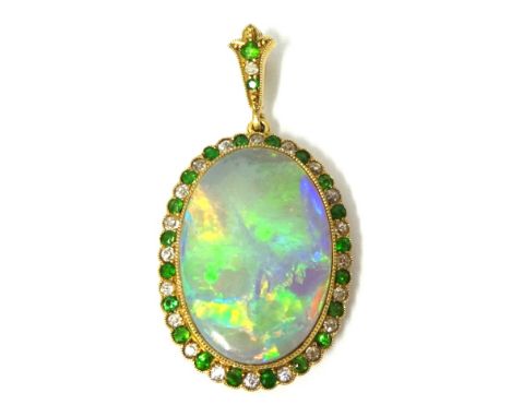 Antique opal pendant with a border of emeralds and diamonds set in yellow metal, approximately 28mm x 20mm