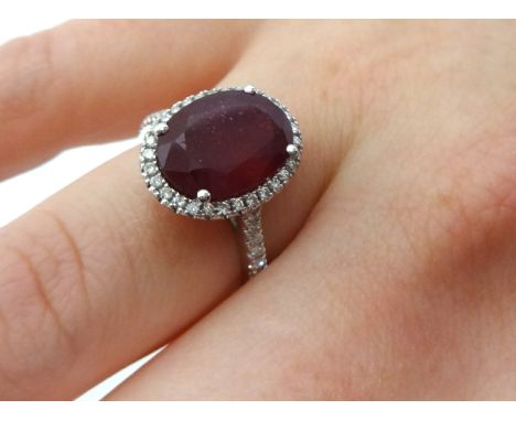 Ruby and diamond oval cluster ring comprising central oval cut ruby weight 5.33 carats surrounded by small round brilliant cu