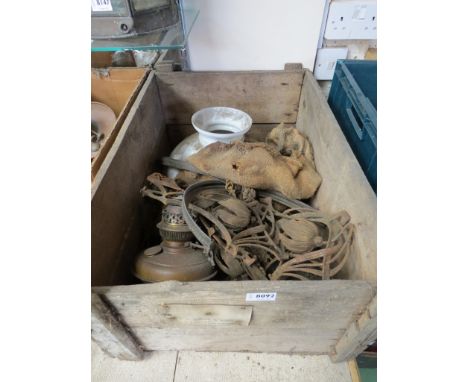 A wooden crate containing a brass rise and fall lamp 