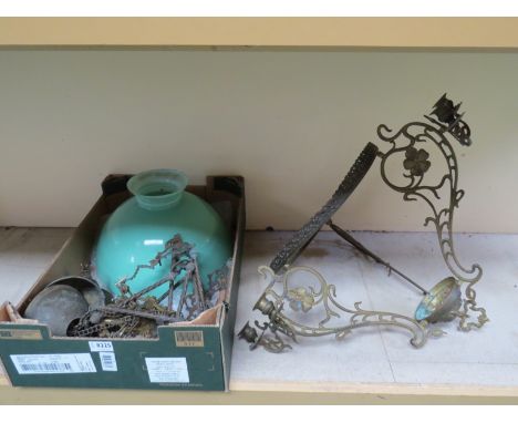 A brass rise and fall oil lamp with green/blue glass shade 