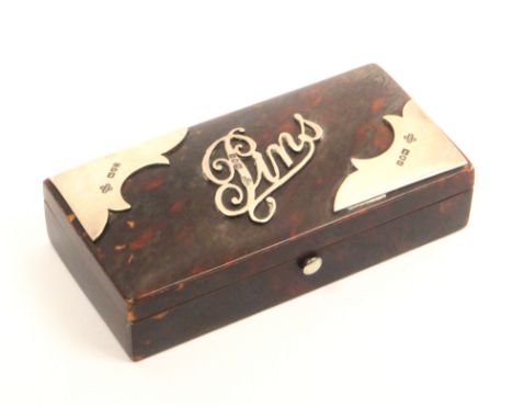A tortoiseshell and silver mounted pin box of rectangular form the lid with applied script 'Pins' with shaped silver mounts t