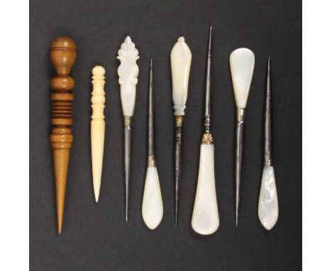Eight stilettos, six with mother of pearl handles including one with gilt mount, a turned wooden example and a 19th Century i