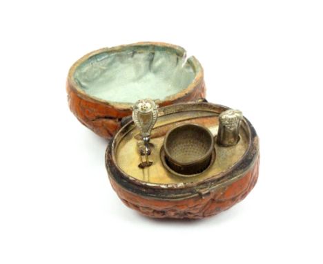 A mid-19th Century etui for a doll contained in a natural walnut, circa 1837, brass hinge and tool plate, the tools comprisin