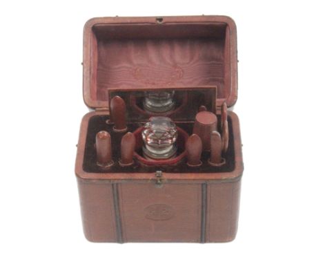 A leather cased sewing companion in the form of a travelling trunk the front stamped in an oval with Royal Coat of Arms and '
