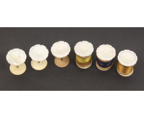 A set of six flowerhead mother of pearl top reel holders on brass stems and bone bases, one with replacement wooden base, 3.4