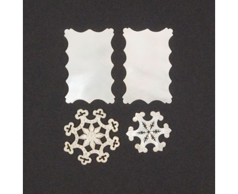 Four mother of pearl thread winders comprising a pair of rectangular shaped outline, 5.2cm and two elaborate snowflake exampl