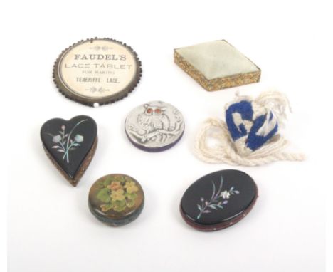 Seven various pin cushions including two in papier mache inlaid in mother of pearl, one oval, one heart shaped, each 5.5cm   