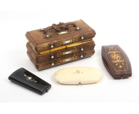 A Victorian leather sewing box and three etui cases, the box in brown leather with gilt and mother of pearl mounts, interlace