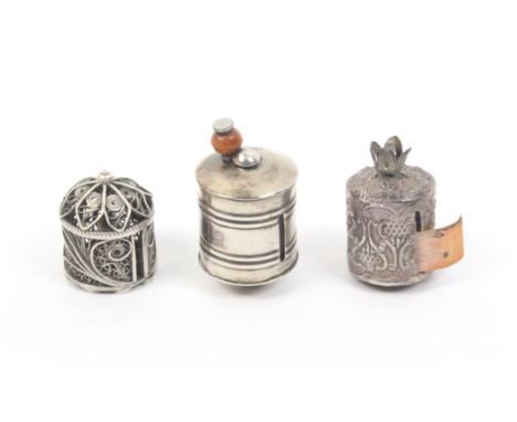 Three 19th Century silver tape measures comprising a silver filigree example lacking tape, 2.3cm, a cylinder form example wit