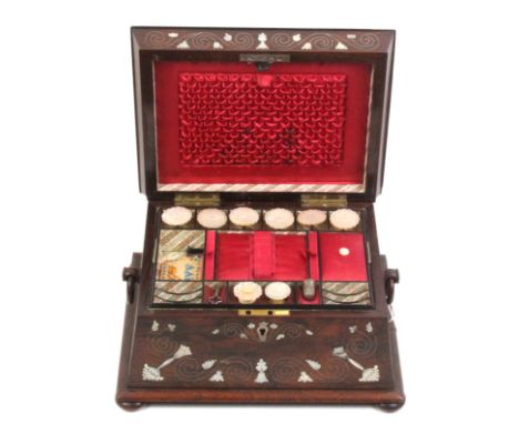 A rosewood sewing box, circa 1840, of sarcophagus form inlaid to the top and front with mother of pearl flowers, and scrollin