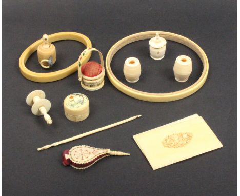 A group of ivory and bone sewing tools comprising a cut bone pin cushion in the form of a set of bellows, 6.8cm, a pail form 