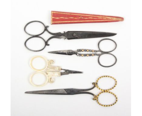 Four pairs of attractive 19th Century scissors comprising a steel pair the file cut arms mounted with gold florets, 8.5cm, a 