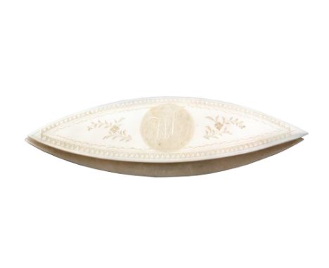 An early 19th Century Chinese engraved mother of pearl shuttle, initialled in a circle 'JW' within flowering branches and a z