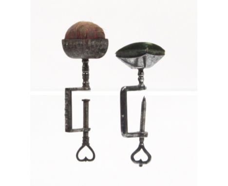 Two 19th Century steel sewing clamps, one with a rectangular decorated frame with pierced heart screw terminal below a trough