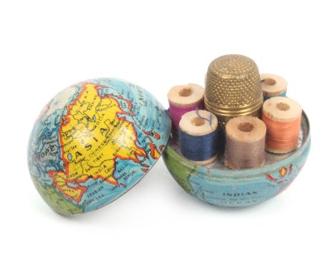A novelty miniature sewing companion contained in a colour printed metal globe, marked 'Made In Germany', the interior with s