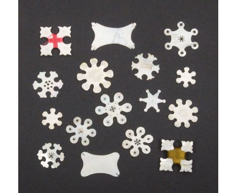 Sixteen mother of pearl thread winders including two pairs of snowflake form, and twelve others, largest 4.5cm               