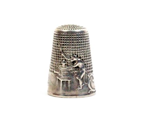 A French silver 'fairy tale' thimble, 'The Monkey and the Magic Lantern', the frieze with a monkey operating a magic lantern,