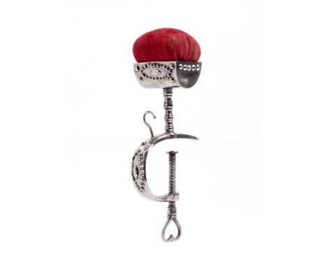 An early 19th Century cut steel sewing clamp the 'C' frame mounted with a hook, heart pierced screw terminal below a trough f