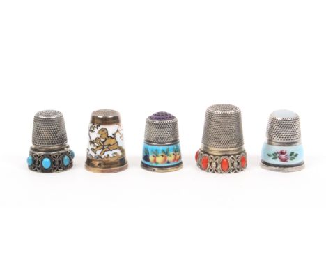 Five attractive continental white metal thimbles, comprising two with stone tops one with an enamel band of flowers, the othe