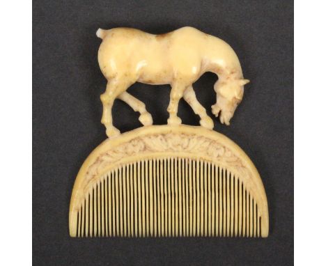 An 18th Century or earlier ivory comb, the semi-circular comb with floral carved border below a figure of a standing horse, t
