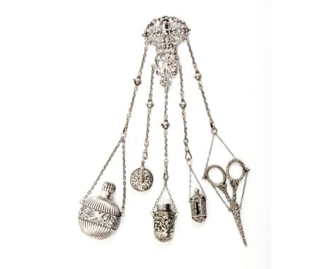 An English silver chatelaine, the hinged hook to an elaborate pierced mount with cupid firing an arrow within scroll and frui