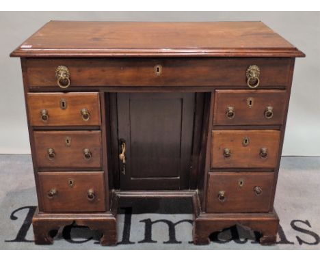 A late George III mahogany kneehole desk, with seven drawers about the knee on bracket feet, 94cm wide x 78cm high.