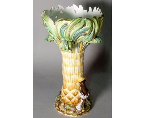 A Continental ceramic centrepiece, formed as a palm tree with figures beneath, 36cm high.