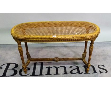 A Louis XVI style green painted oval stool, on fluted tapering supports, 90cm wide x 52cm high.
