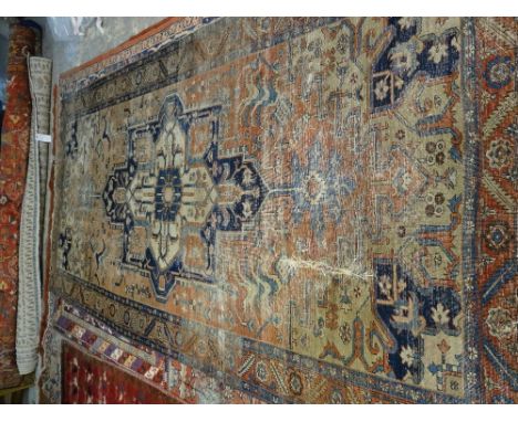 A Tabriz carpet, the madder field with large medallion, 320cm x 161cm. 